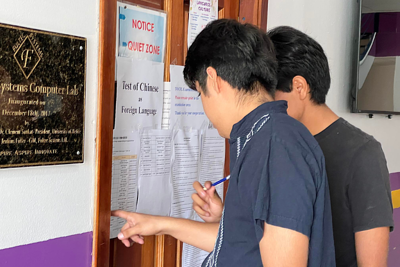 Examinees search for their designated seats in the exam hall