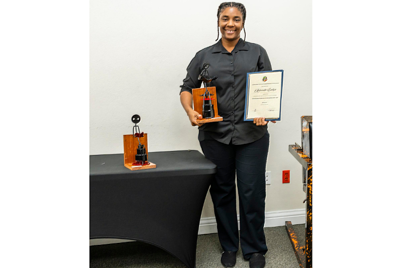 The participant with her certificate and her work.