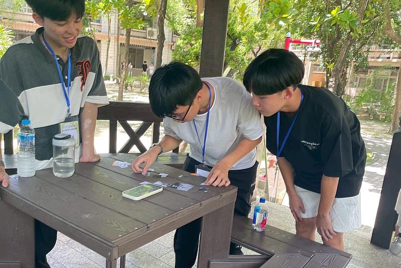 南大經管系新生分組挑戰解謎關卡，認真動腦並展現團隊合作默契。