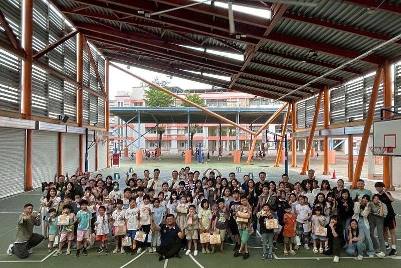 復興國小管弦樂團的學生與南大經管系學會成員共同合影，笑容洋溢，為迎新活動留下美好印記。