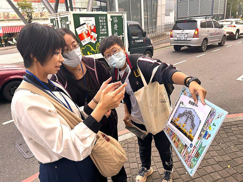 南臺科大USR計畫成果展示。圖為永村副教授體驗透過AR（擴增實境）技術展現海安路口鐵支牆所運用的神農街文化元素的應用情境，了解南臺科大如何以新科技進行記憶遺產的挖掘與轉譯。