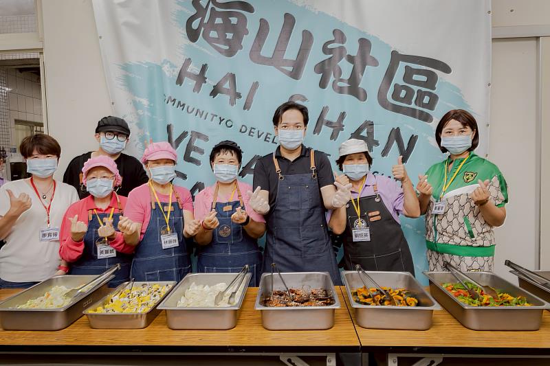 邱臣遠代理市長化身一日志工為長輩盛菜、陪伴共餐。