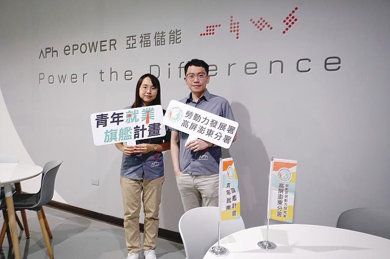 鈞婷(左)與職場導師(右)於公司LOGO與標語前合影。