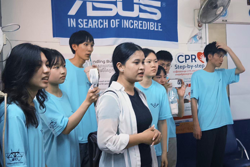 Ann (Center), a Cambodian university student, returned to the program this year to assist as an interpreter.