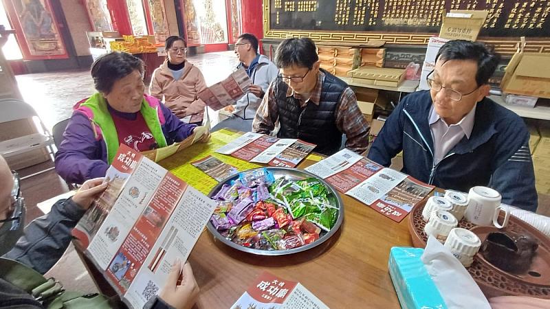 黃世輝副校長與社區理事長、廟務人員現場翻閱工藝DM,交流成功廟的工藝與故事。