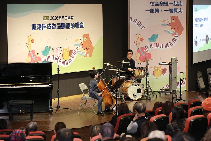 孩子站在舞台中央拉起大提琴，父親則以爵士鼓伴奏，信義學堂日前舉辦的「2026新年音樂會：讓陪伴成為最動聽的樂章」，帶來一場層次分明的音樂演出。（左：陳時悠，右：米奇）