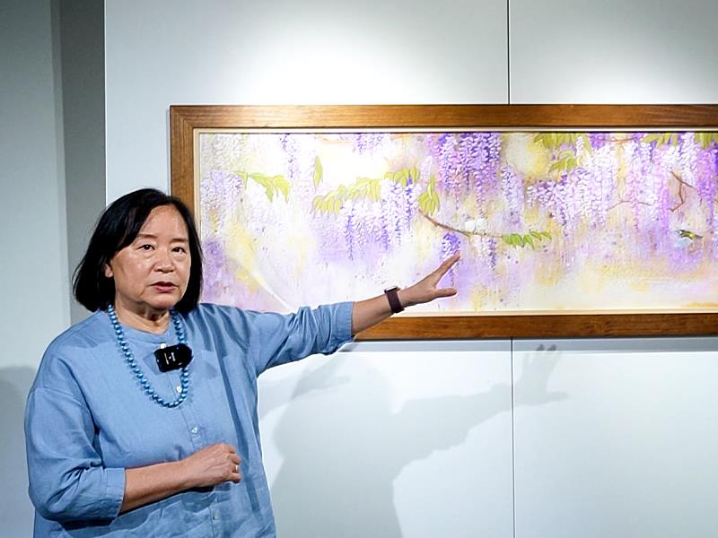 藝術家馬靜志親自為觀眾導覽展出作品,分享畫面中的花卉意象與創作歷程,細緻說明色彩、層次與媒材運用,引領觀眾走進作品所蘊含的時間與情感。
