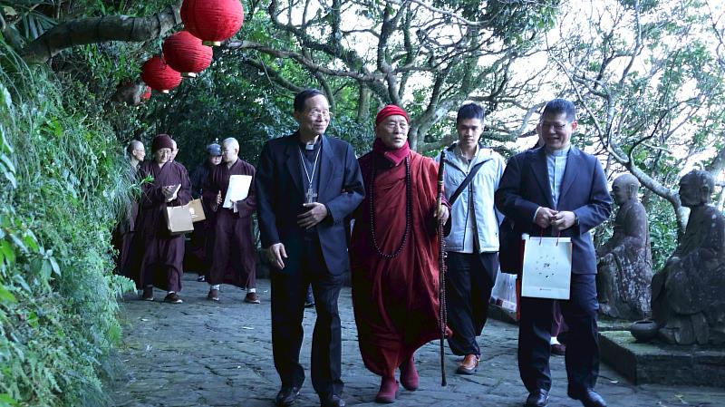 鍾安住總主教(左1)、心道法師(左2)、中華民國宗教與和平協進會秘書長林之鼎神父(右1)及詹均為秘書步行於羅漢步道中。(圖由靈鷲山佛教教團提供)
