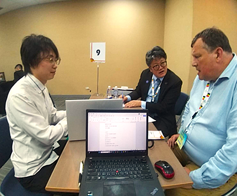 【產學對接】林韋成同學（左）參與臺比智慧醫療論壇B2B媒合會，與比利時AWEX經貿組長及CEREF教授（右）洽談技術合作。