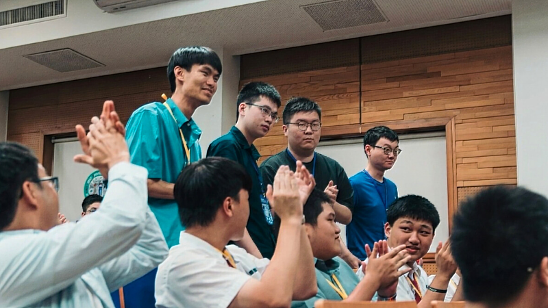 Members of the NYCU team iTron react with applause as the championship results are announced at the final round of the Kibo-RPC.