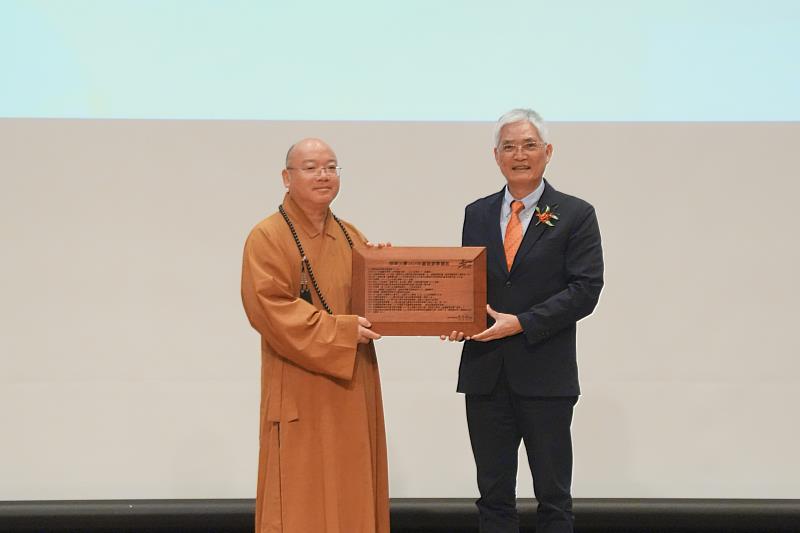 南華大學舉辦創校30週年校慶典禮，高俊雄校長（右）向董事長心保和尚（左）呈獻辦學績效。