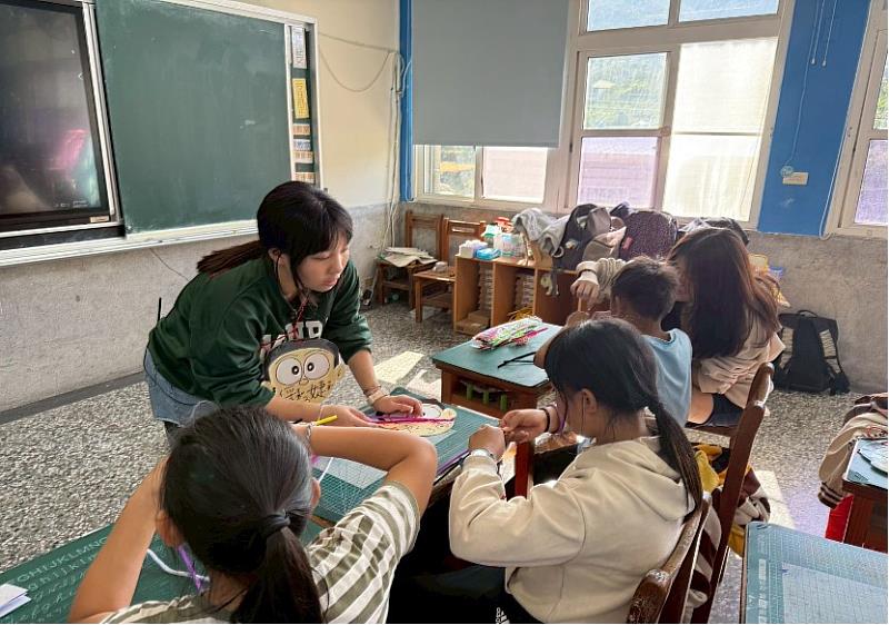 賈綵婕帶領小朋友一同製作自然實驗課實驗作品。