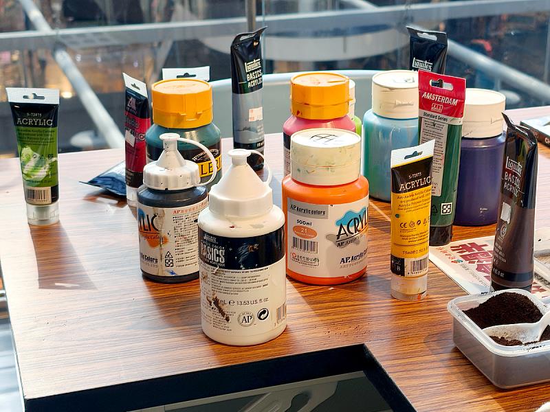 現場準備多樣顏料與自然媒材，透過色彩與肌理堆疊，讓畫面產生豐富層次。