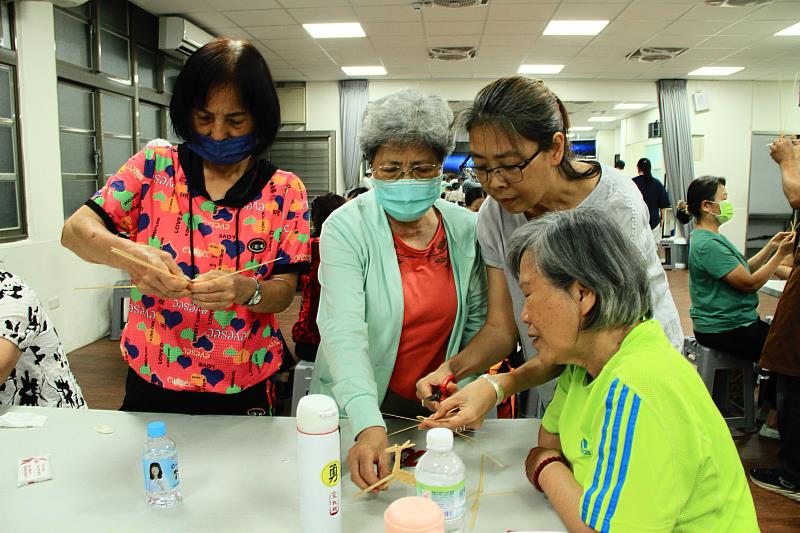 竹編老師於課堂中個別指導學員組裝技巧。