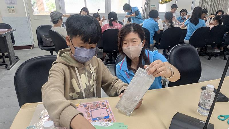 義工伙伴引導孩子完成作品。