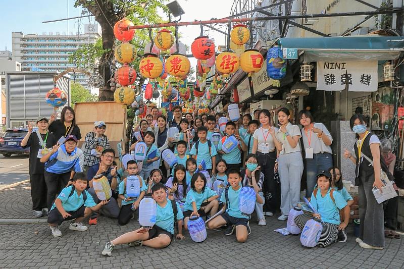 南臺科大USR師生團隊與龍崗國小師生在走讀五條港街區博物館戶外課程後，於神農街口合照。