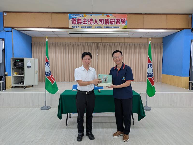 救國團南投縣團委會總幹事李明組致贈禮品予中華青少年活動教育協會榮譽理事長周志岳。