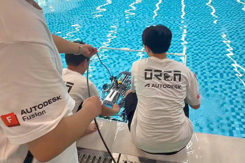 The ORCA AUV Team prepares and deploys their autonomous underwater vehicle during the 2026 SAUVC, conducting final system checks before competition missions in the pool-based test environment.