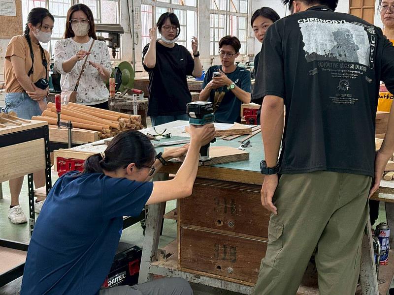 學員在講師的教導下，使用簡易工具進行國產材椅板鑽孔。