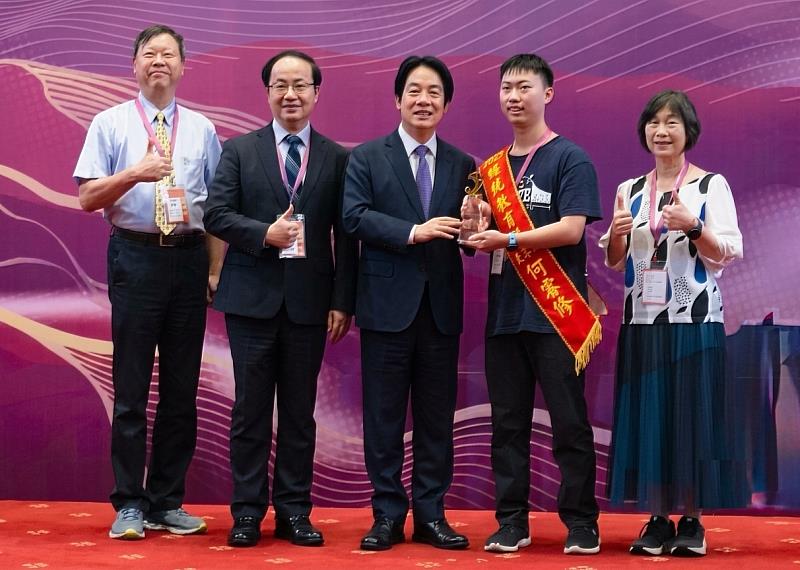 新竹市自閉症協會理監事、何睿修及其家人一起在頒獎台與賴清德總統合影。