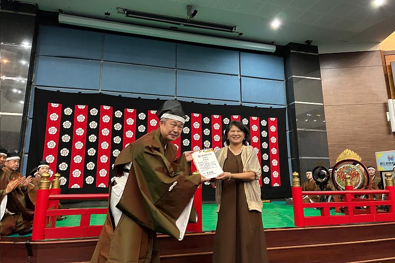 應日系主任黃愛玲老師(右)致贈感謝狀給東京天理雅楽会代表岩崎広之先生(左)。