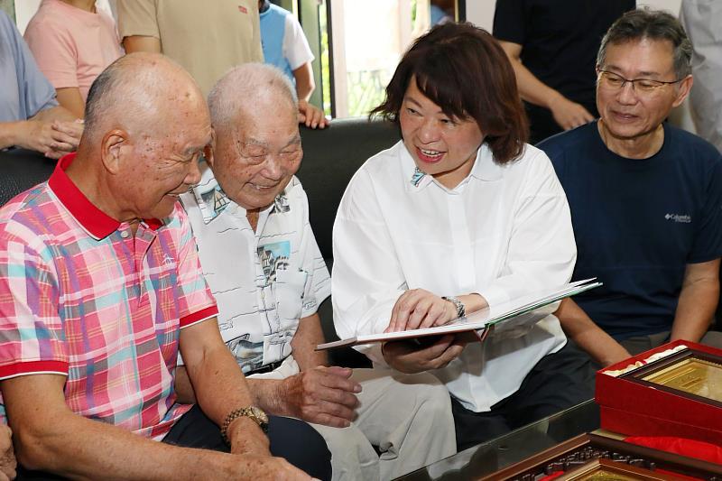 黃敏惠市長贈送百歲人瑞江平鎮由專業攝影師拍攝記錄人瑞生平事蹟之風華錄乙冊。
