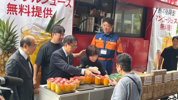 黃市長為災區民眾送上冰涼果汁打氣。